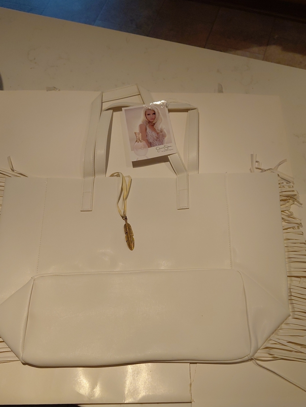 Jessica Simpson White Fringe Tote with Gold Feather Charm